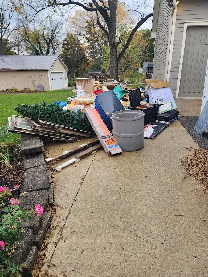 Dumpster being loaded with debris for Estate Cleanout Dumpster Rental in Shavano Park